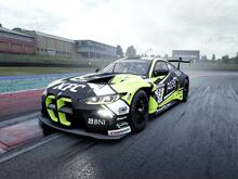BMW M4 GT3 going over a kerb in the wet, with a WRT Dubai 24H livery