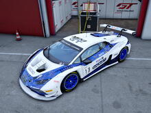 3/4 screenshot of a white lamborghini huracan GT3 evo 2. It has blue wheels, sponsors and a marble-like metallic blue and gold decal 