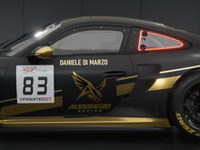 Side view of Daniele Di Marzo’s black and gold Auronero Racing Porsche 992 GT3 R, number 83, in Assetto Corsa Competizione.