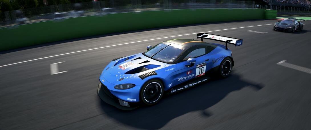 Blue Aston Martin going through Monza's main straight.