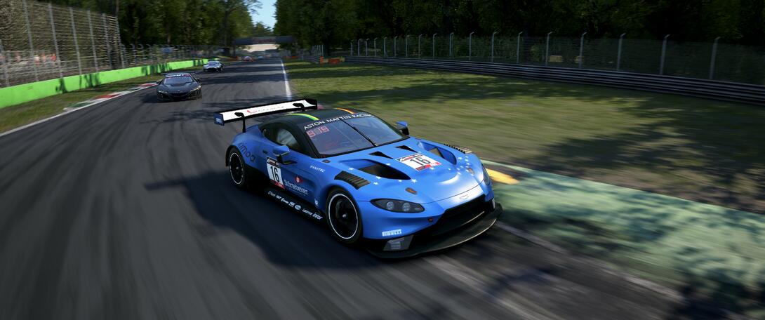 Blue Aston Martin going through the Ascari chicane.