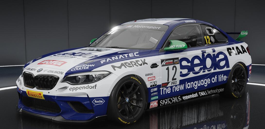 Hideously over sponsored car in blue & white, plastered with the logos of various companies in the Life Sciences sector