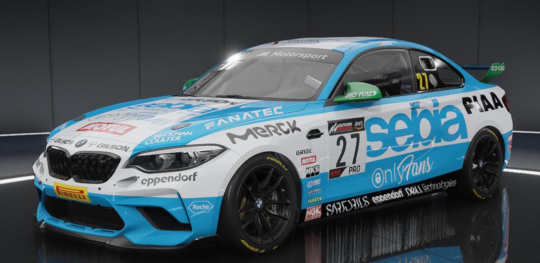 Hideously over sponsored car in light blue & white, plastered with the logos of various companies in the Life Sciences sector