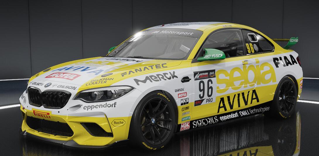 Hideously over sponsored car in yellow & white, plastered with the logos of various companies in the Life Sciences sector